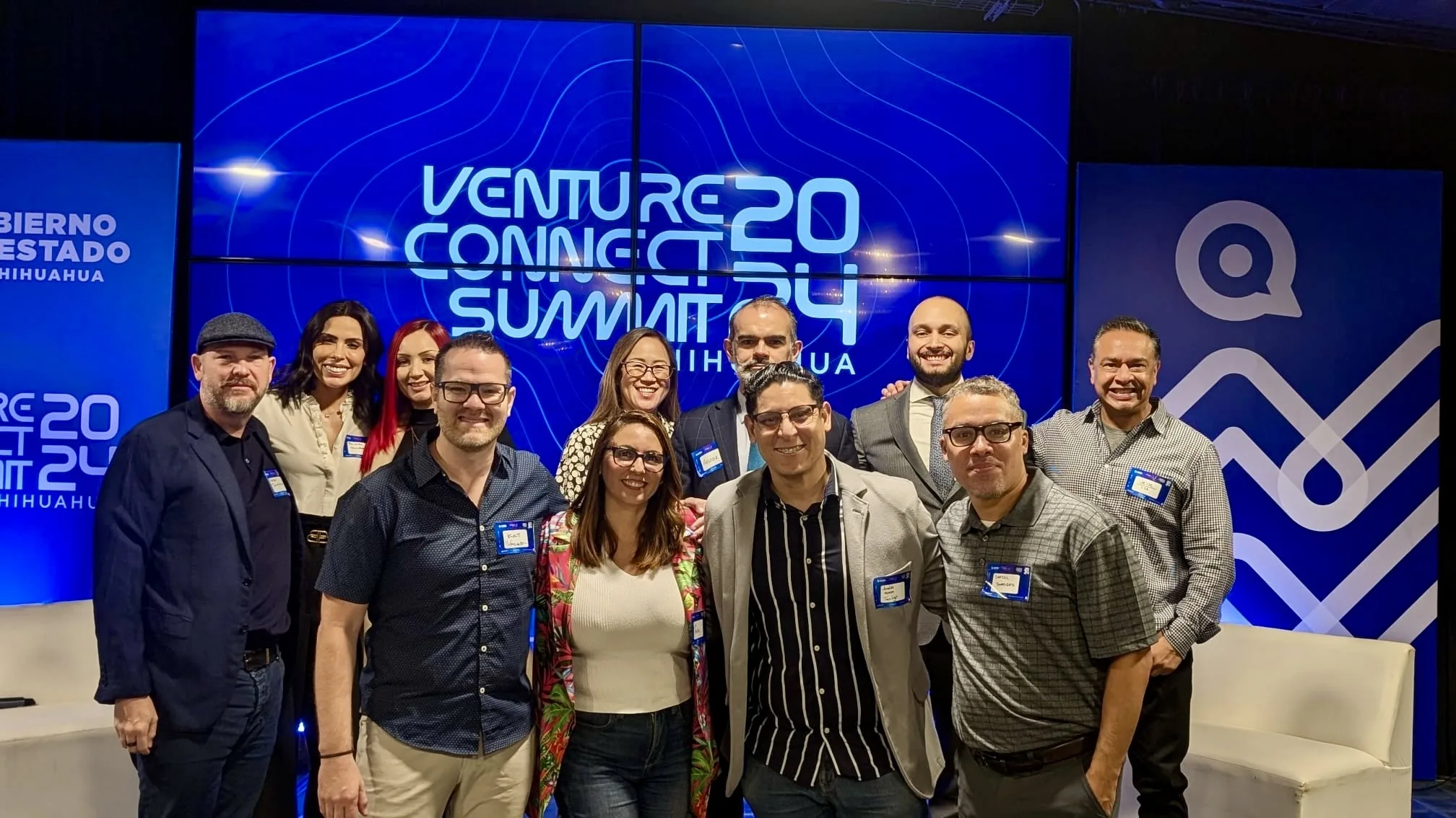 Founders and investors in front of the Venture Connect Summit 2024 screen